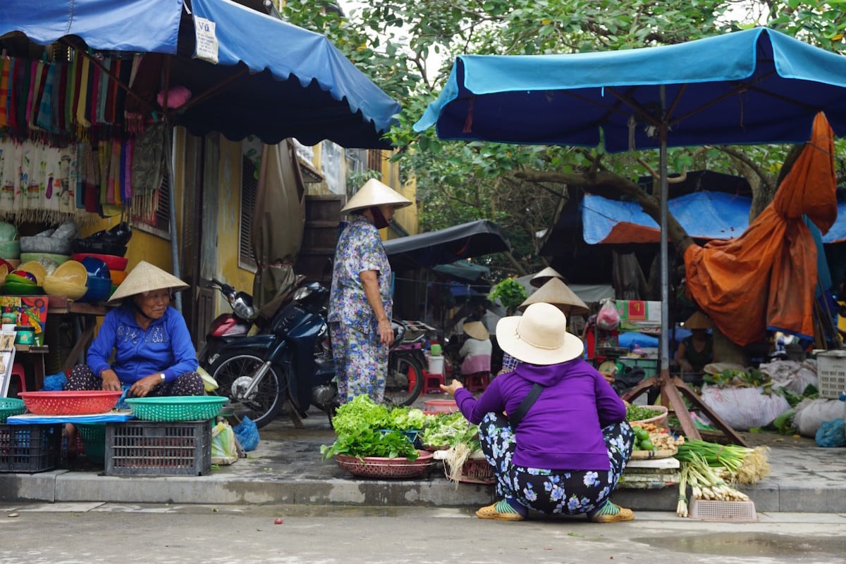 Selling vegetables just outside the market.